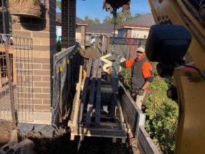 Retaining wall construction with tight access