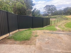 Colorbond fence joined to Post & netting fence.