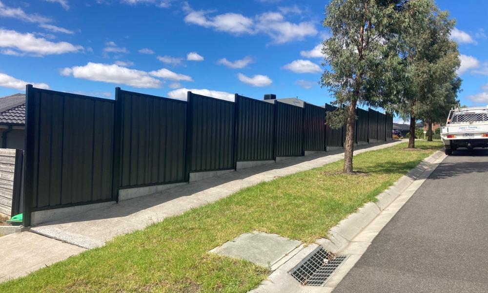 Stepped Colorbond Boundary fence on top of Concrete Sleepers