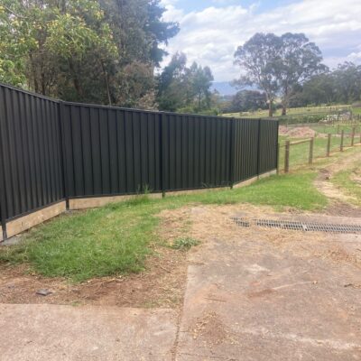 Colorbond fence joined to Post & netting fence.