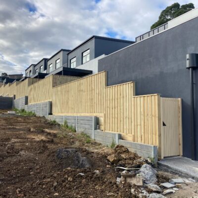 Stepped Timber Capped fencing above retaining walls - Mirvac.